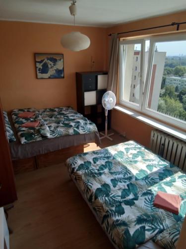 a bedroom with two beds and a window at Panoramic views in Krakow