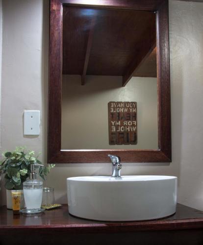 a bathroom with a sink and a mirror at Zoete Rust Boutique Hotel in Lephalale