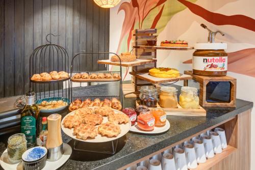 a buffet with many plates of food on a counter at Radisson Pinheiros in Sao Paulo