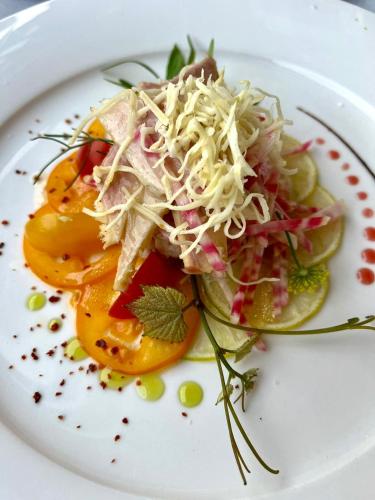 a plate of food with a salad on it at Panoramahotel Steirerland in Kitzeck im Sausal
