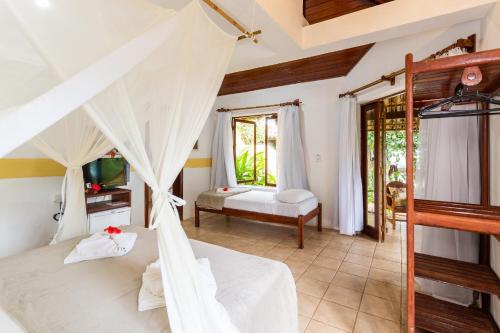Ένα ή περισσότερα κρεβάτια σε δωμάτιο στο Pousada Villa Bianca