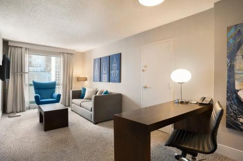 a living room with a desk and a chair at Hilton Chicago Magnificent Mile Suites in Chicago