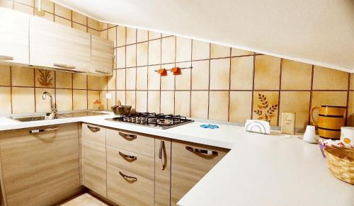 a kitchen with wooden cabinets and a stove top oven at Casa alla Costa in Mormanno