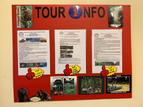 a poster on a wall with pictures on it at Prima B&B Hostel in Sandakan