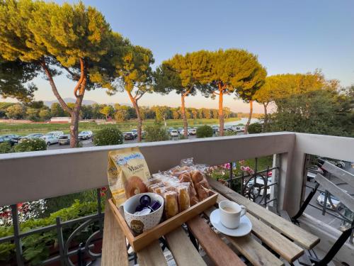 a tray of bread and coffee on a table on a balcony at La Casa di Eli Appartamenti in Pisa