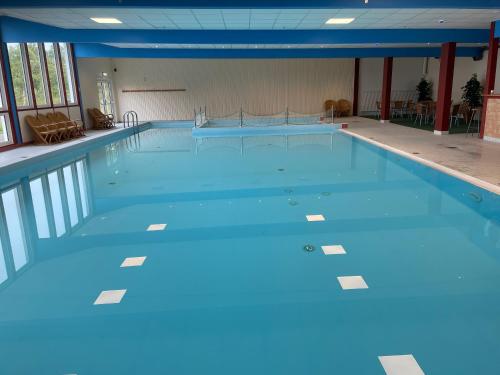 a large swimming pool with blue water at Storlien Högfjällshotell AB in Storlien