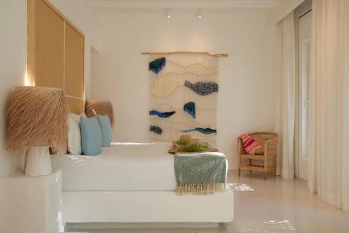 a bedroom with a bed and a chair in it at Octant Vila Monte in Moncarapacho