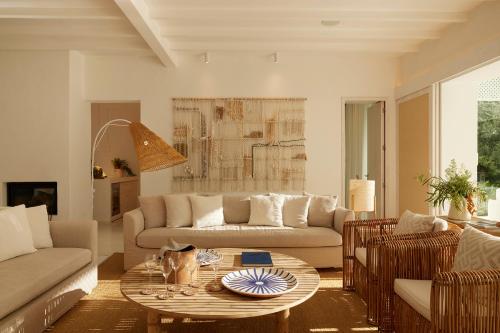 a living room with a couch and a table at Octant Vila Monte in Moncarapacho