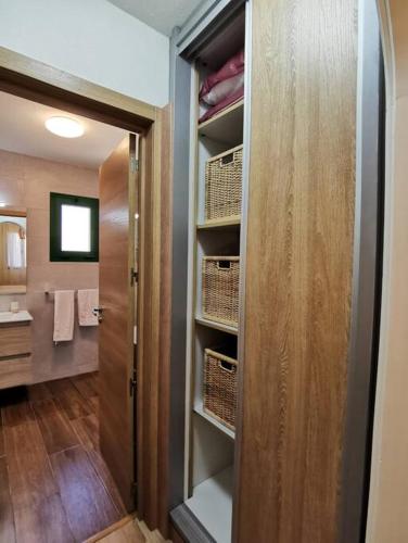 a bathroom with a walk in closet with a door at Montes Blancos in Costa Calma