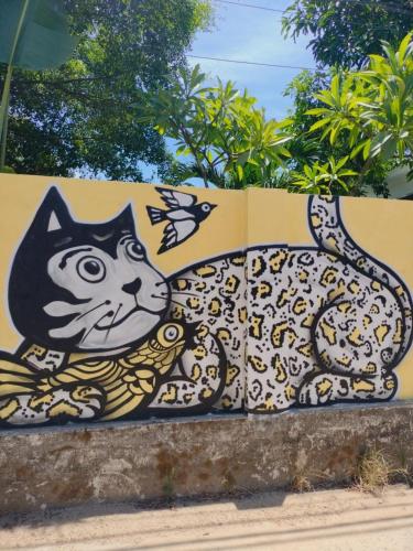 a cat painted on the side of a wall at Lama Beach Villa in An Bang
