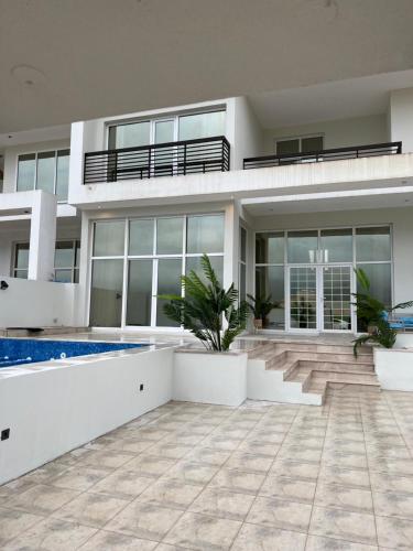 a large house with a swimming pool in front of it at فيلا صلاله بالم salalah palm villa in Salalah