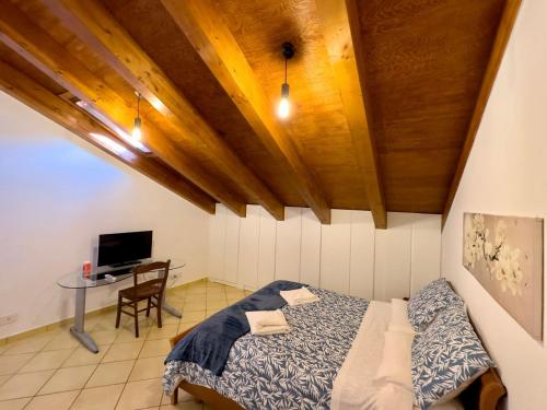 a bedroom with a bed and a desk with a tv at Home Sweet Home Apartment in Agerola