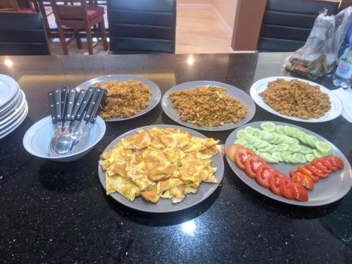 a group of plates of food on a table at Villa Munjul Indah - Majalengka in Jatipamor