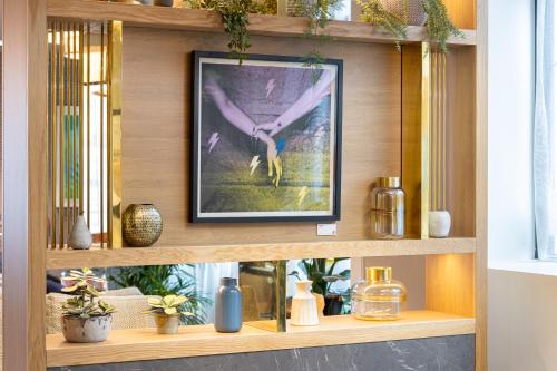 a framed picture on a shelf in a room at Point A Hotel London Kings Cross – St Pancras in London