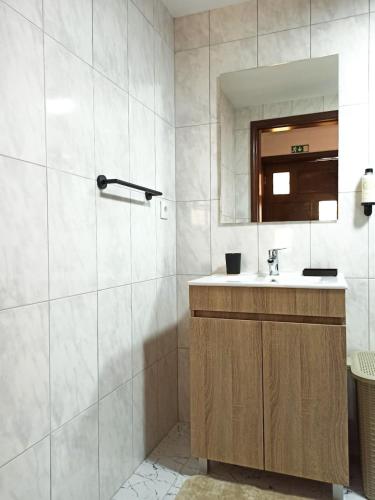 a bathroom with a sink and a mirror at Casa da Belavista in Trofa