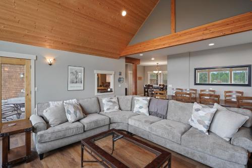 a living room with a couch and a table at Five Peaks Home with Soaking Tub in Bend