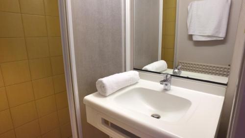 a bathroom with a sink and a mirror at VVF Les Ecrins Champsaur in Saint-Bonnet-en-Champsaur