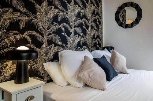 a bedroom with a bed with pillows and a wall at AU COEUR DES MONTAGNES in Pierrefitte-Nestalas