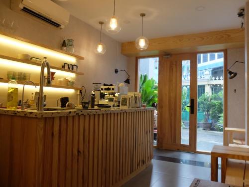 a kitchen with a counter with a sink at HALF Coffee N Dorm in Ho Chi Minh City
