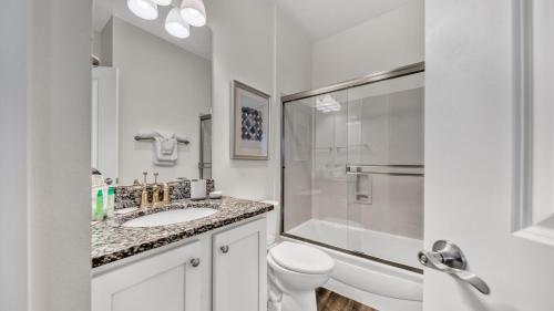 a white bathroom with a sink and a toilet at Hidden Lake Condos 113 - Short walk to the beach along Scenic Hwy 30A in Santa Rosa Beach in Santa Rosa Beach