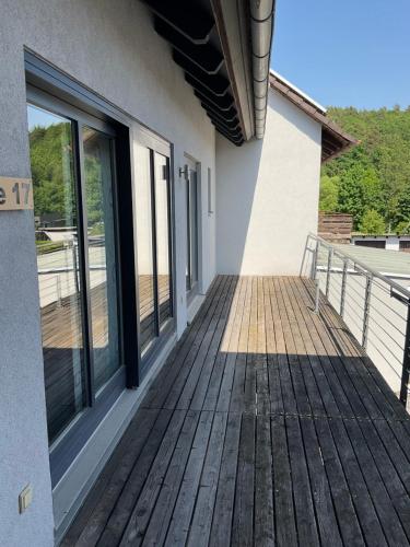 a porch of a house with sliding glass doors at Ferienwohnung mit Balkon in Oberelsbach