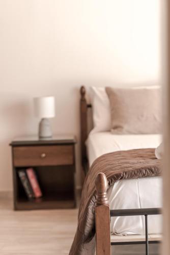 a bedroom with a bed and a nightstand with a bed sidx sidx at Sofia - Yiota Studios & Apartments in Tsilivi