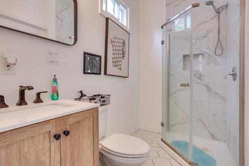 a bathroom with a shower and a toilet and a sink at Vibrant East Orange Townhome Near Red Bull Arena! in East Orange