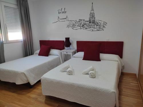 a bedroom with two beds and a sign on the wall at "La Villa de Iker" con Piscina, Barbacoa, Aire Acondionado a 5 mint de "Puy du Fou" in Argés