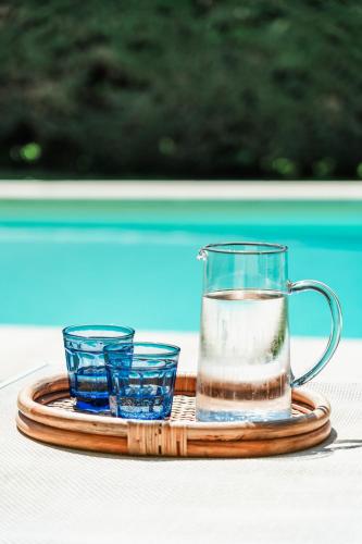 a tray with a pitcher and two glasses on a table at Rovezzano B&B in Florence