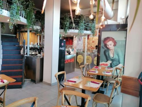 a restaurant with tables and chairs and a staircase at Florence Comfort B&B in Florence