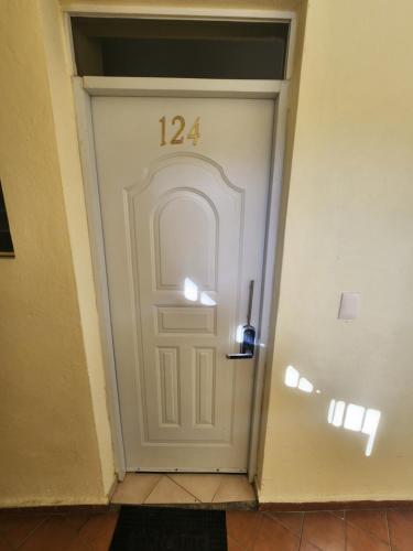 a white door with the number on it at Full size 2 bedrooom 2 bath condo split in Sosúa