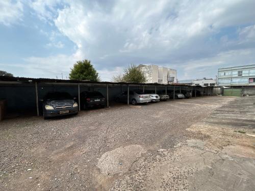 a row of cars parked in a parking lot at Aloys Hotel in Cascavel