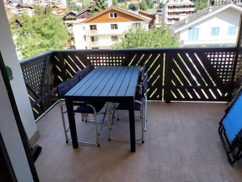 a blue table and chairs on a balcony at BERTUZZI HOMES "Luxury Chalet" in Aprica