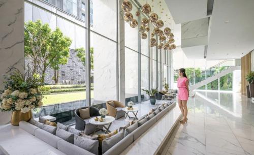 a woman standing in the lobby of a building at Hyde Sukhumvit 11 Branded Suites in Bangkok