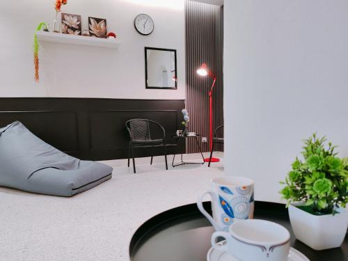 a living room with a table and a chair at A Humble Abode Homestay By irainbow in Ipoh
