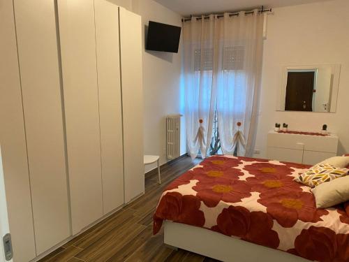 a bedroom with a bed and a television in it at SestoHome26 in Sesto San Giovanni