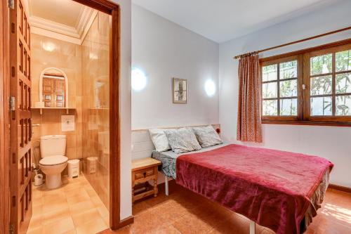 a small bedroom with a bed and a shower at Cozy two bedrooms apartament in the heart of Los Gigantes in Acantilado de los Gigantes