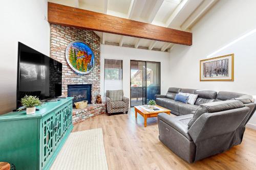 a living room with a couch and a fireplace at Mountain Shadows in Incline Village