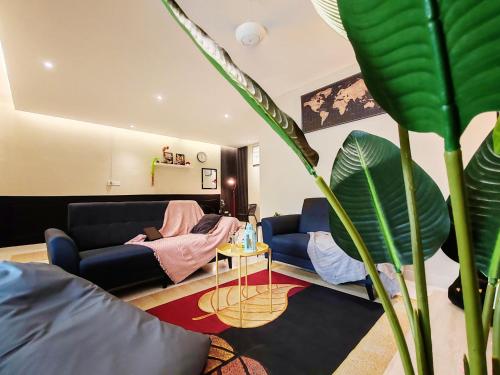 a living room with a couch and a plant at A Humble Abode Homestay By irainbow in Ipoh
