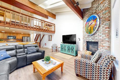 a living room with a couch and a fireplace at Mountain Shadows in Incline Village