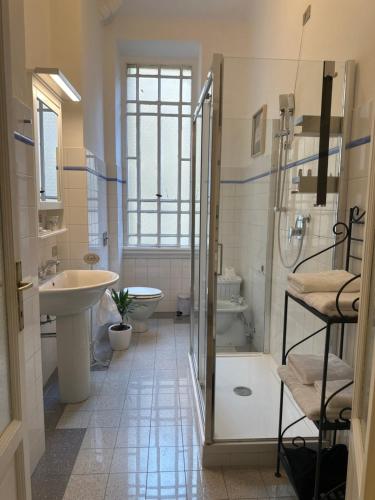 a bathroom with a shower and a toilet and a sink at Liberty Home in Milan