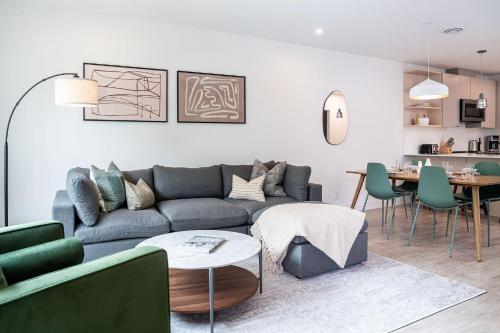a living room with a couch and a table at Serenity Now by Revelstoke Vacations in Revelstoke