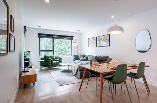 a living room with a table and a couch at Serenity Now by Revelstoke Vacations in Revelstoke