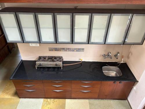 a kitchen with a sink and a counter top at RaghavaVijayam in Kolhapur