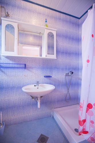a bathroom with a sink and a mirror and a tub at Apartments Dunja Piric in Lopar