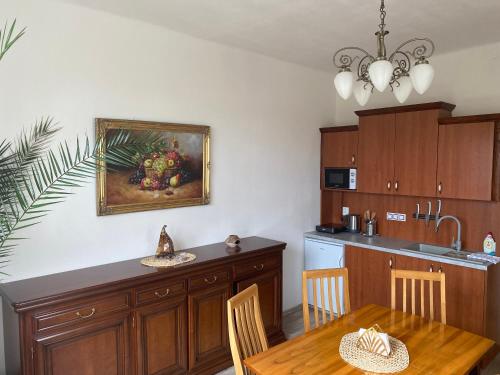 a kitchen with a table and a dining room at Vila 1921 in Jevišovice