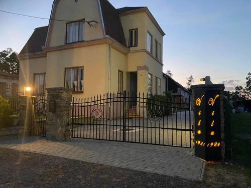 a house with a wrought iron gate in front of it at Vila 1921 in Jevišovice