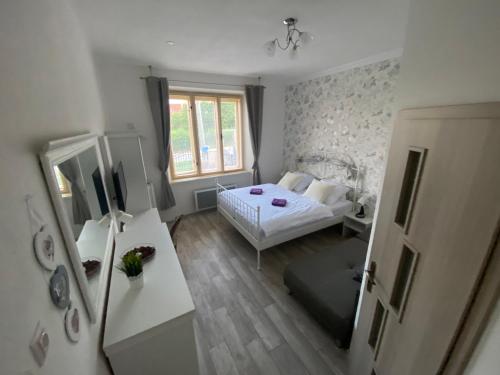 a small bedroom with a bed and a window at Vila 1921 in Jevišovice