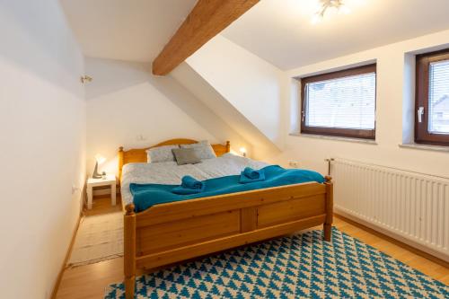 a bedroom with a wooden bed in a attic at Apartma Ivano in Bohinj