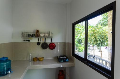 a kitchen with a window and a counter with a sink at Новый дом Koh Phangan in Baan Tai